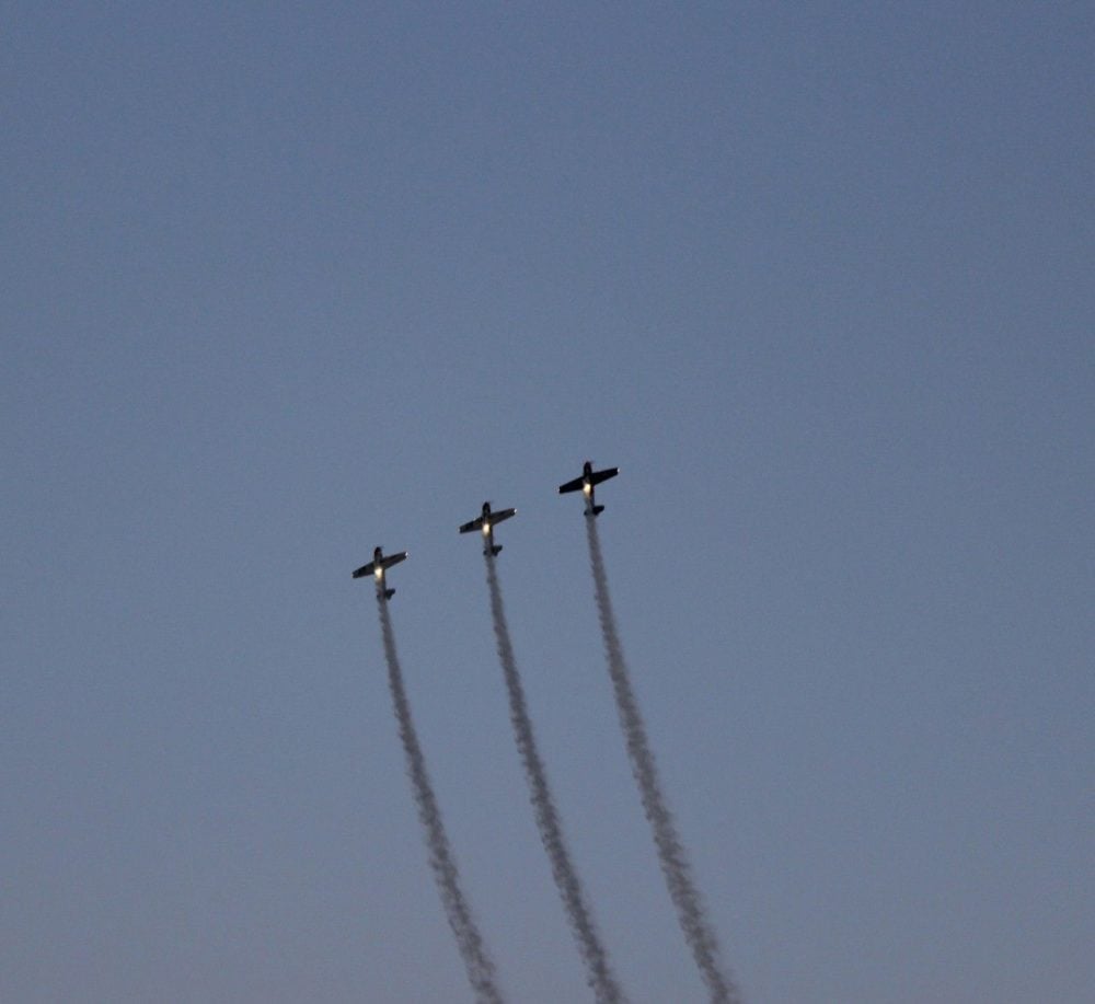 Night airshow with planes going straight up