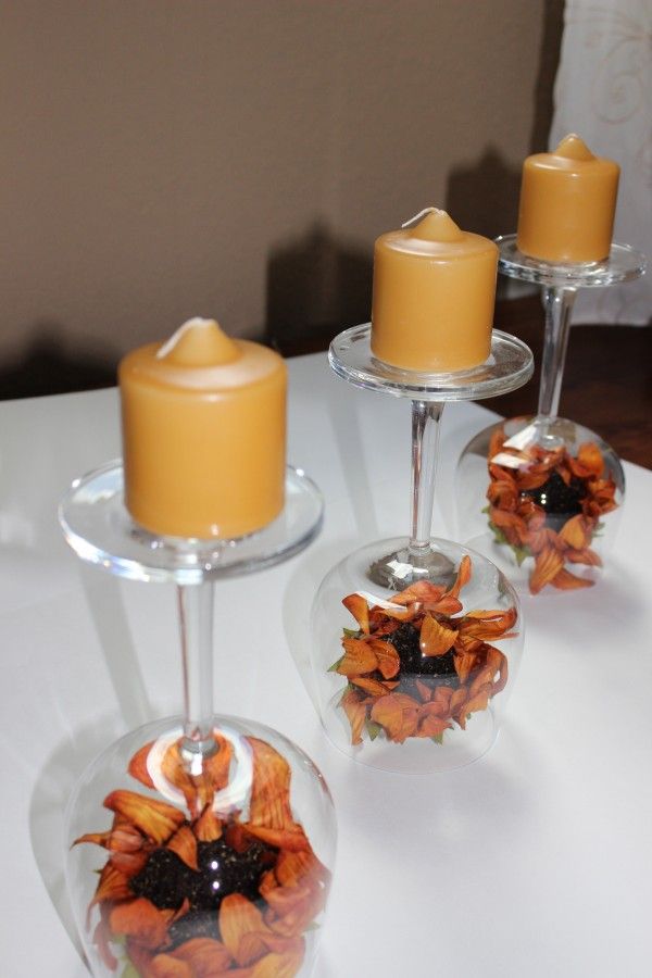 Wine glass centerpiece with fall sunflowers.