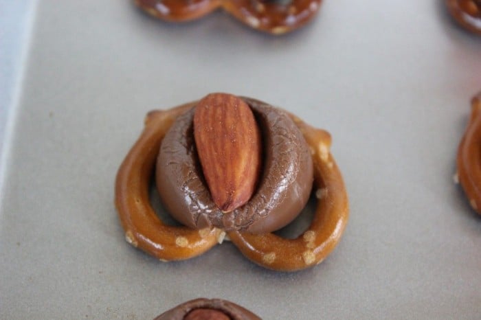 Pretzels with Hershey Kisses and almonds.