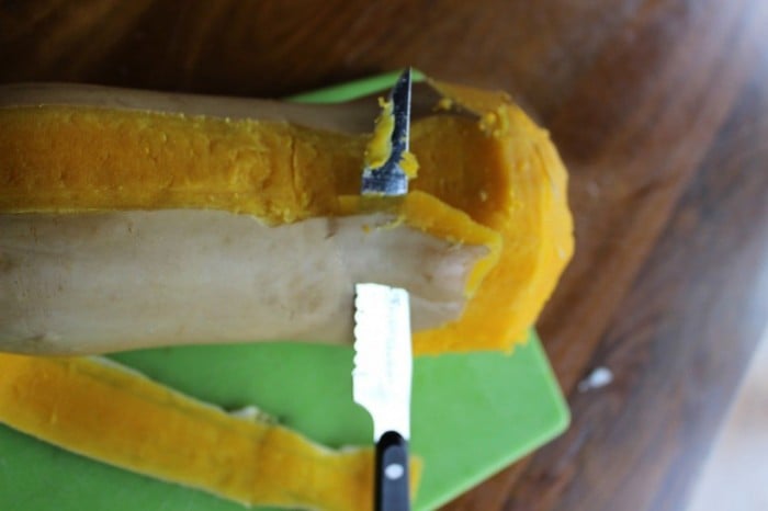 Butternut squash being peeled after it has been baked. Skin comes off easily.