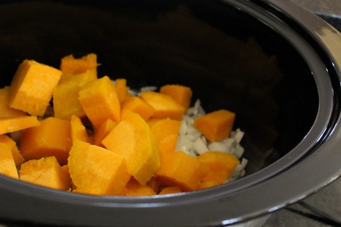 butternut squash cut into pieces in the crockpot