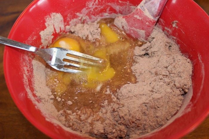 Mixing bananas, chocolate cake mix and now eggs to the three ingredient chocolate banana muffin batter.
