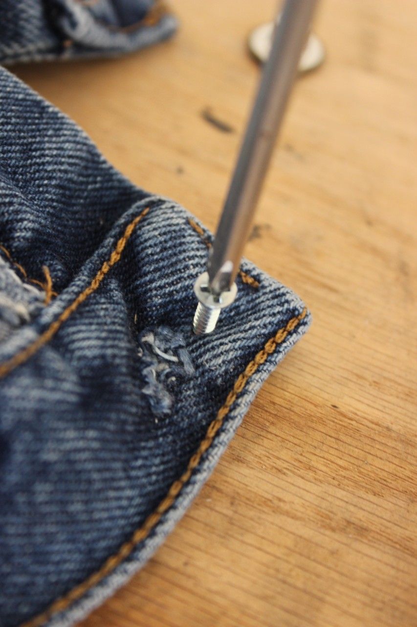 Putting on buttons to resize your jeans or replace your button
