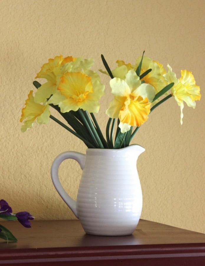 Spray painted white pitcher with daffodils 