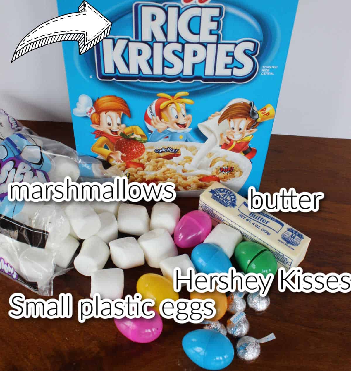 Ingredients for Easter egg treats including Rice Krispie treat cereal, marshmallows, butter, Hershey Kisses, plastic eggs.