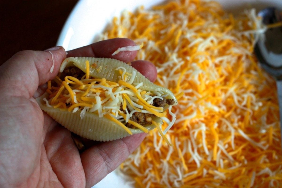 a large pasta shell filled with taco meat and cheese.