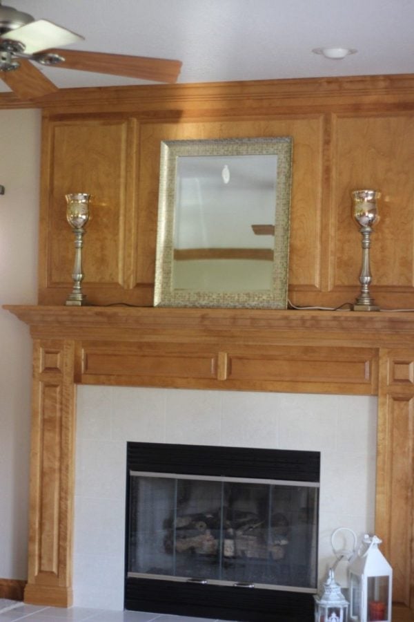 beginning to decorate mantle with large mirror and lamps 
