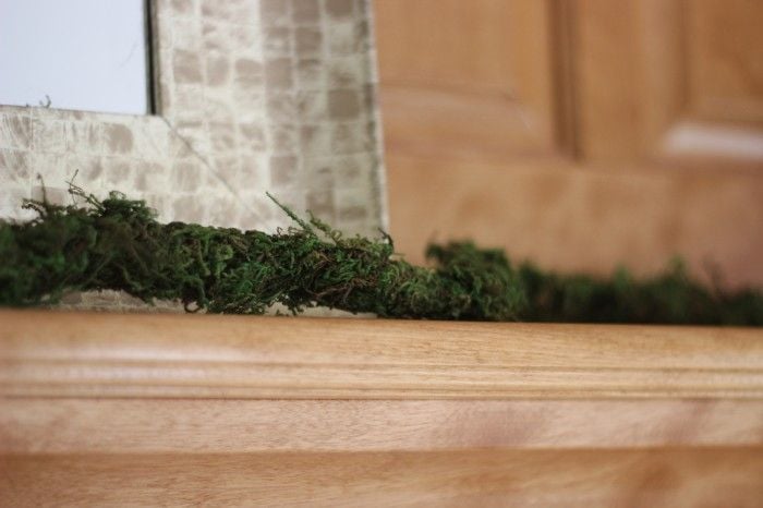 using green moss garland to hide mantle wires