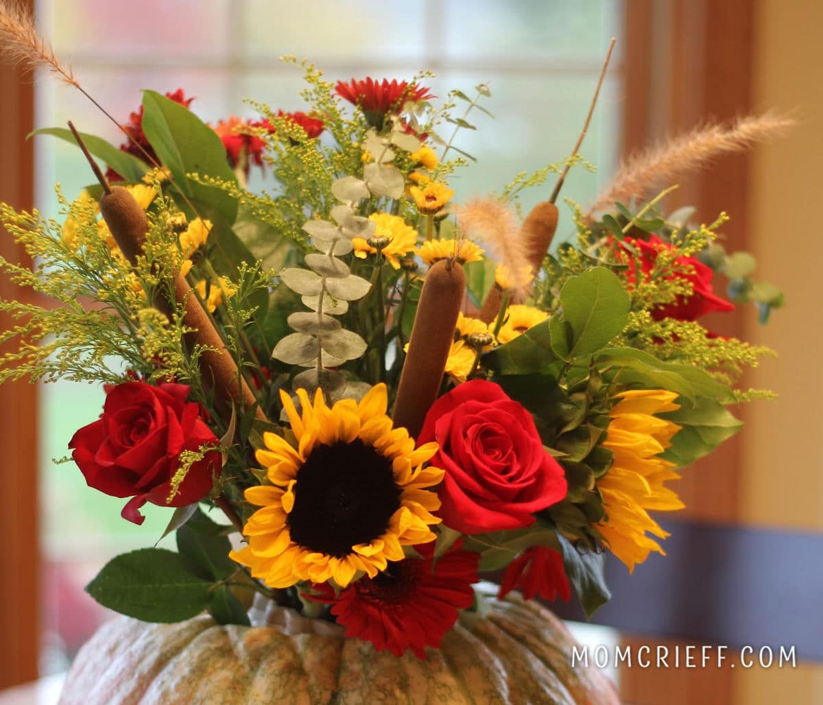 closeup of fall pumpkin vase centerpiece