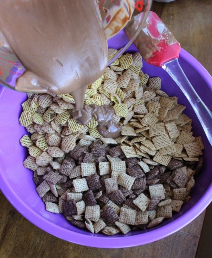 The chocolate mixture being poured onto the cereal mixture