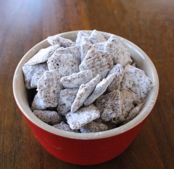 Puppy chow in a small red bowl.