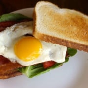 bacon lettuce tomato and fried egg sandwich