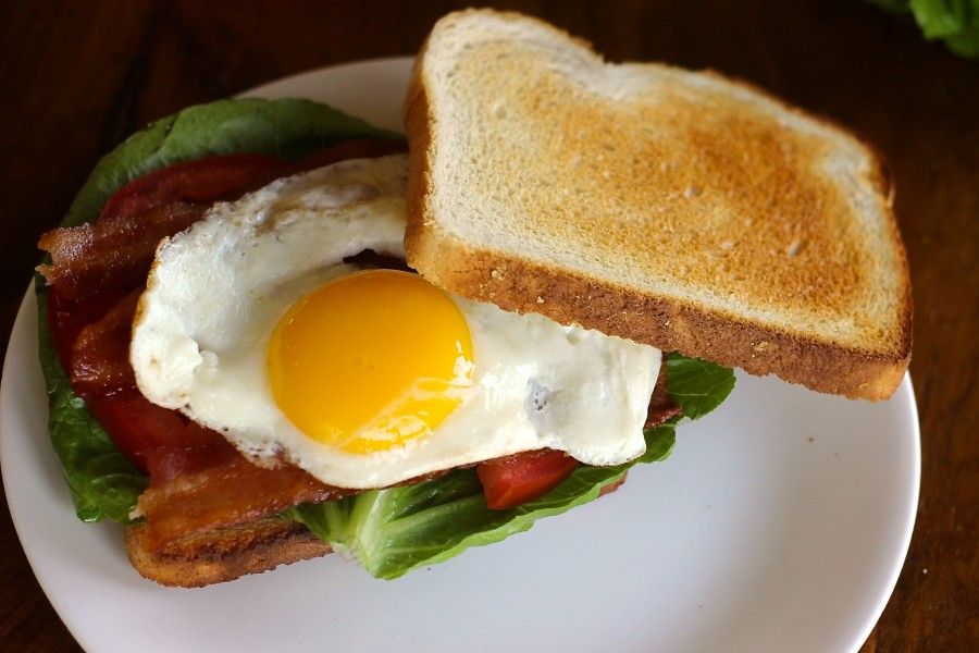 bacon lettuce tomato and fried egg sandwich