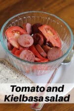 Tomato and kielbasa salad in a clear bow.