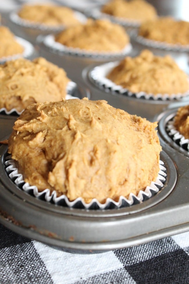 freshly baked pumpkin spice muffins in a muffin tin