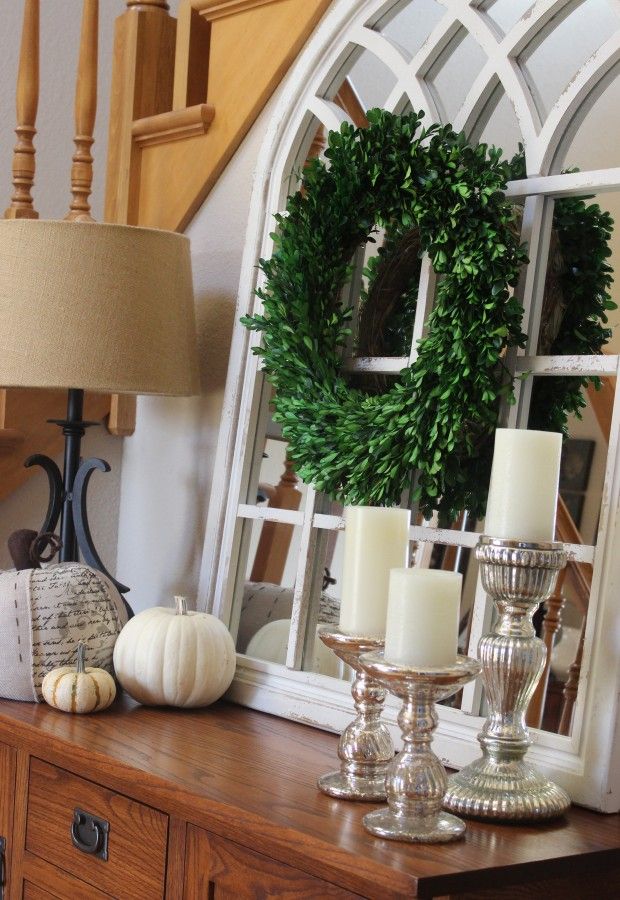 Neutral fall display using mercury glass candleholders with white candles, white pumpkins and my neutral fabric pumpkin.  All in front of my white chippy mirror with a boxwood wreath in the center!