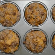 pumpkin chocolate chip muffins in muffin tins.