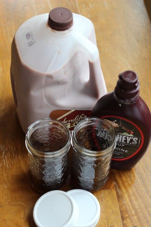 chocolate milk, coffee and chocolate syrup ready to be poured into mason jars