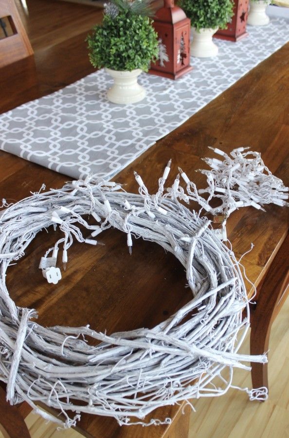 wrapping white sprayed grapevine wreath with white lights.