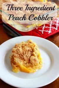 A plate of peach cobbler in front of a pan of hot cobbler.