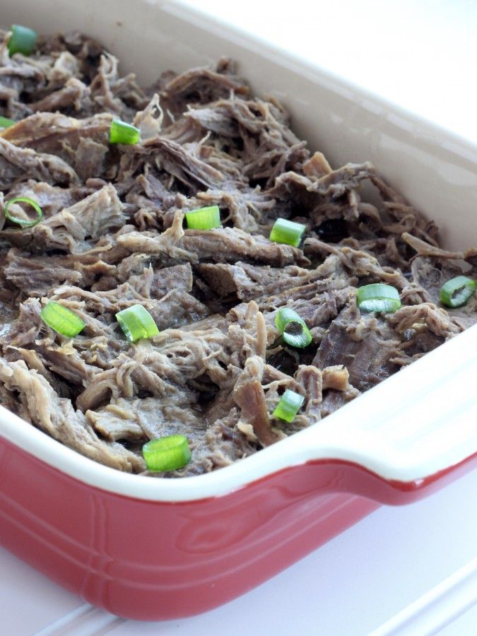 Shredded beef in a red dish ready to serve.