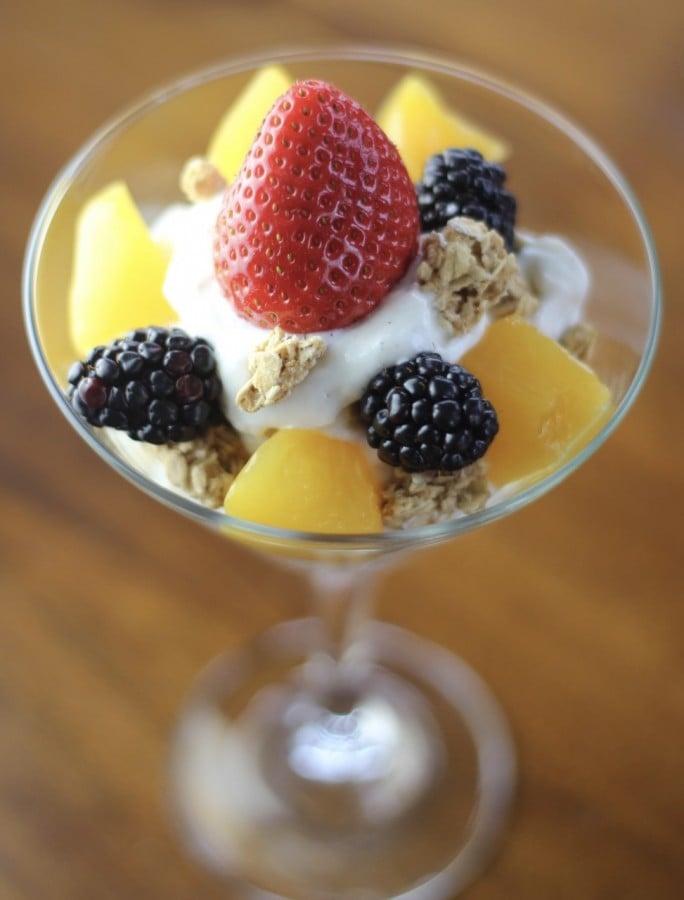 martini glass with yogurt, granola and fresh fruit