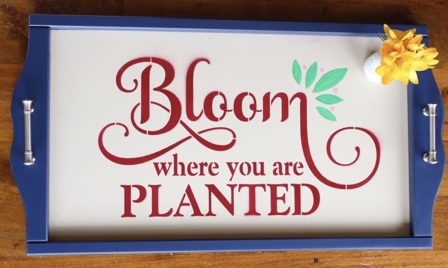 Bloom Where You Are Planted stenciled on red onto a blue upcycled tray