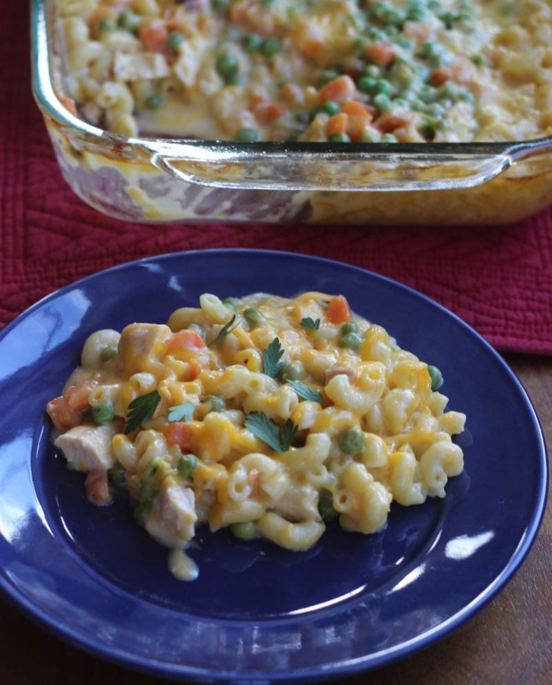 chicken, noodles and cheese casserole with bright colored vegetables