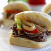 philly cheesesteak steak sandwich. Sliced steak on a roll with cheese, cooked onions and peppers.