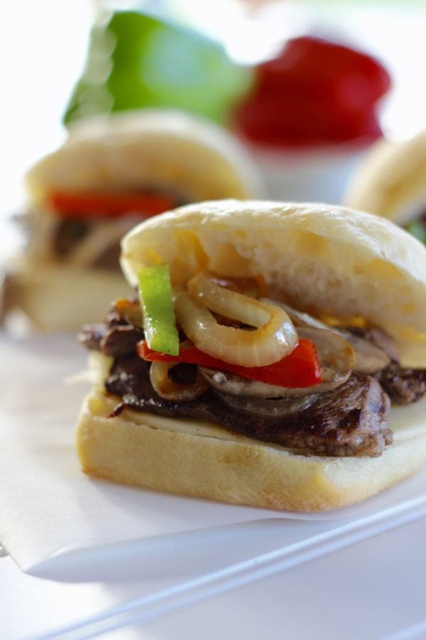 philly cheesesteak steak sandwich. Sliced steak on a roll with cheese, cooked onions and peppers.