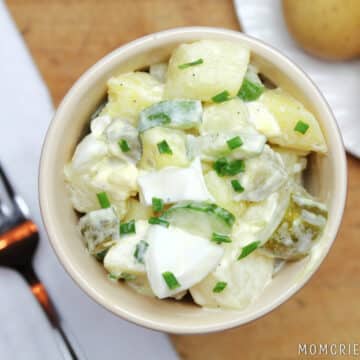 Potato salad in a small dish with a fork to the left.