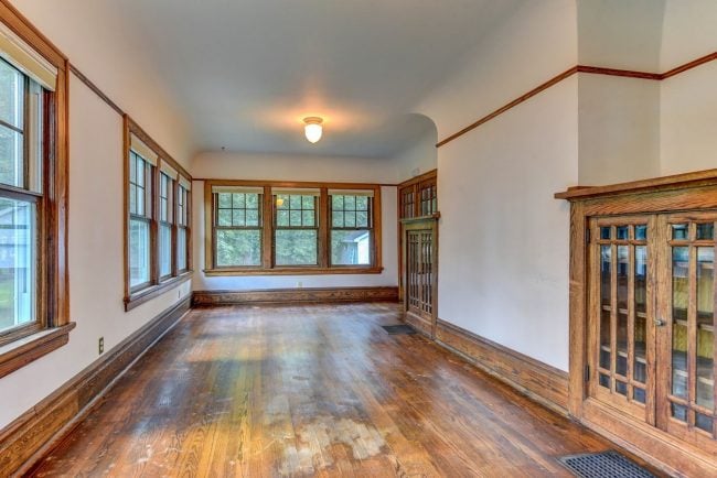 Wooden floors, built in cabinets and a plethora of windows in the sunroom.