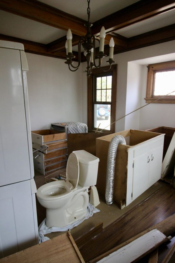 Toilet and kitchen cabinets in the dining room.