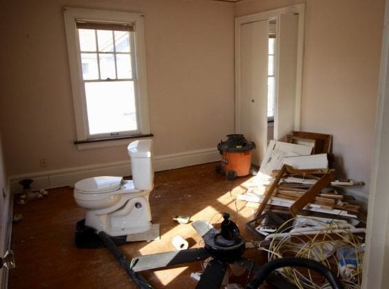 Toilet temporarily in the bedroom during bathroom remodel.