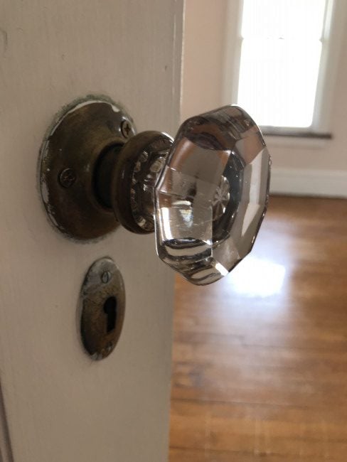 Original crystal doorknob on a door to one of the bedrooms.