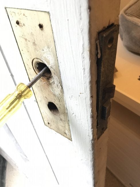 Using my screwdriver to get my mortise lock out of my door.