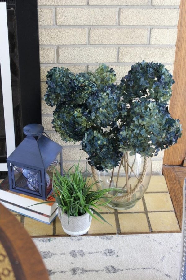 blue lantern with a large vase of blue hydrangeas