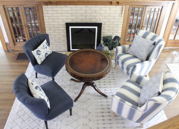 blue accent chairs in front of the fireplace in my blue themed living room in my vintage 1920's house.