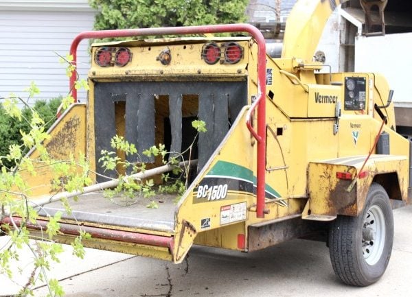 a closeup of the part of the woodchipper that the tree branches get fed into. 