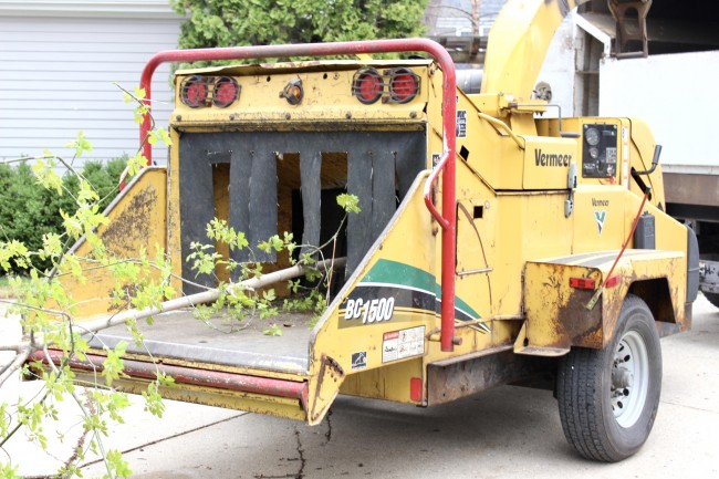 a closeup of the part of the woodchipper that the tree branches get fed into.