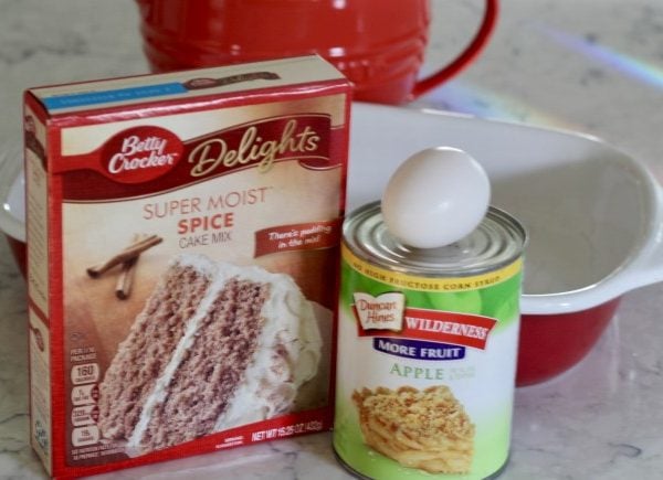 A box of spice cake mix, a can of apple pie apples and an egg