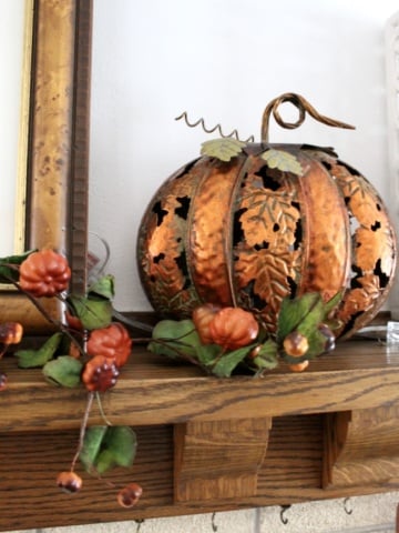 copper pumpkin in front of green ceiling tin