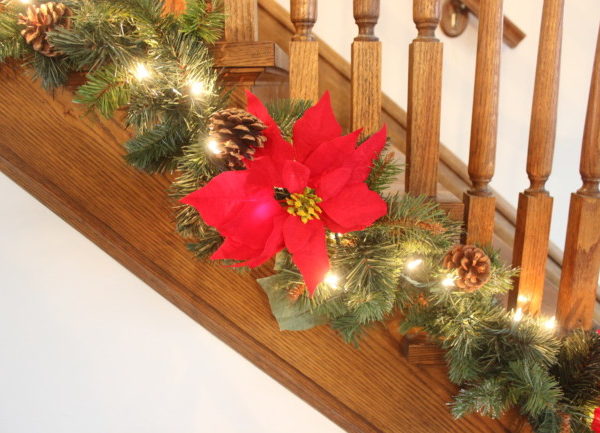 red pointsetta on my stairway Christmas garland