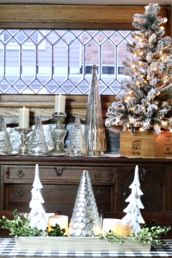 My Christmas dining room decorated with white candles, mercury glass and a small flocked tree.