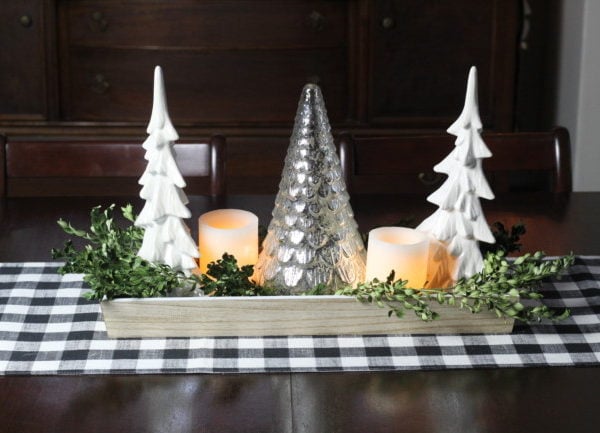 Christmas table centerpiece with two white ceramic trees, a mercury glass tree and some dried boxwood