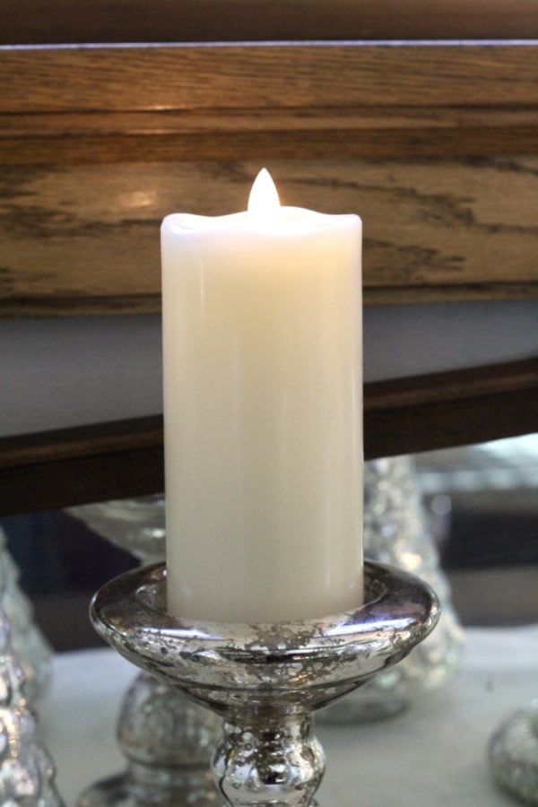 White candle on a mercury glass holder