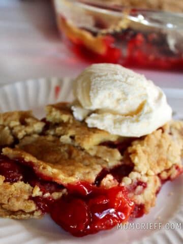 cherry cobbler topped with a scoop of vanilla ice cream