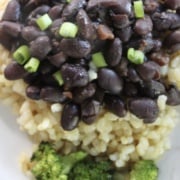 black beans on bed of rice with a side of broccoli