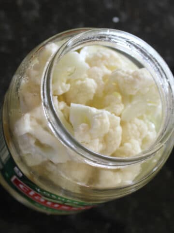 cauliflower in a used pickle container