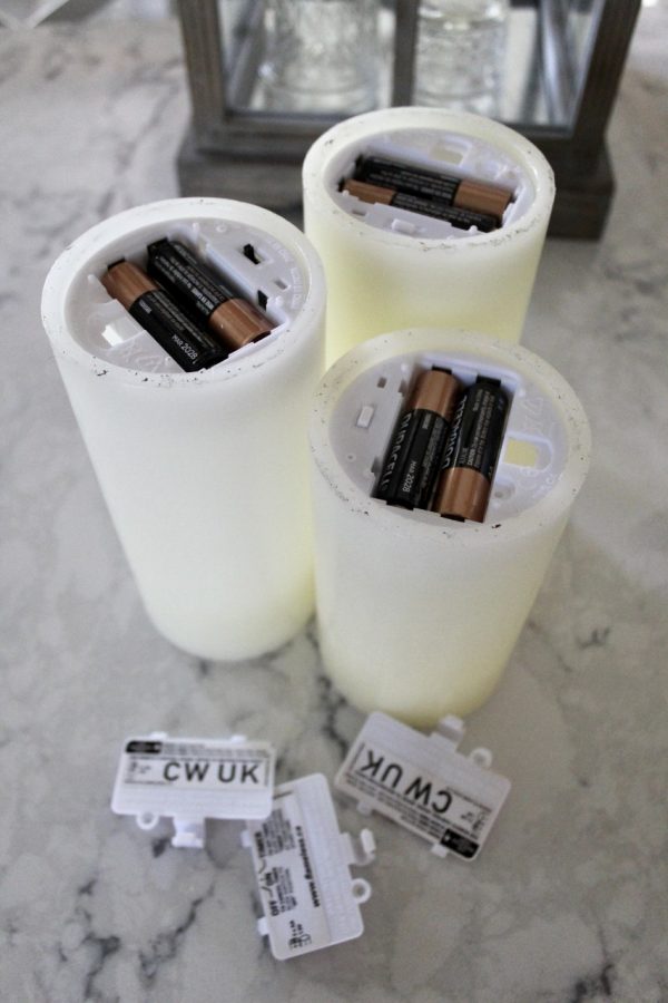 Batteries put into white candles